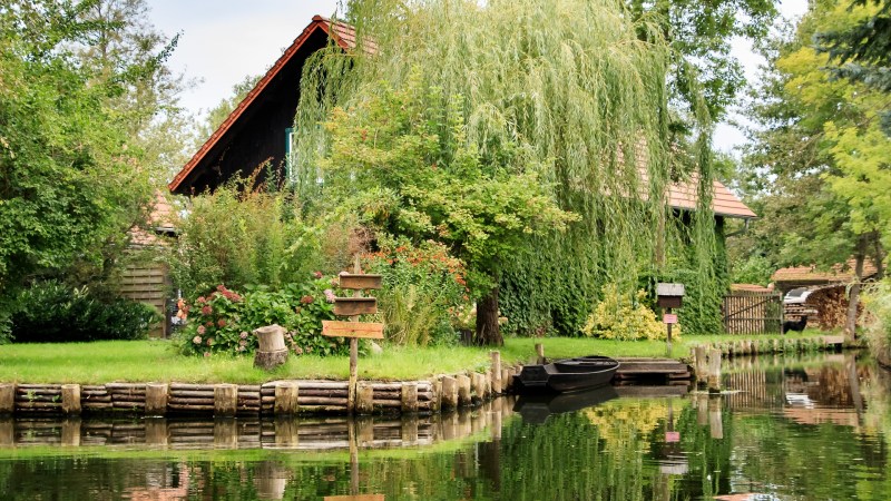 Foto von einem traditionellem Haus an einem Fluss im Spreewald